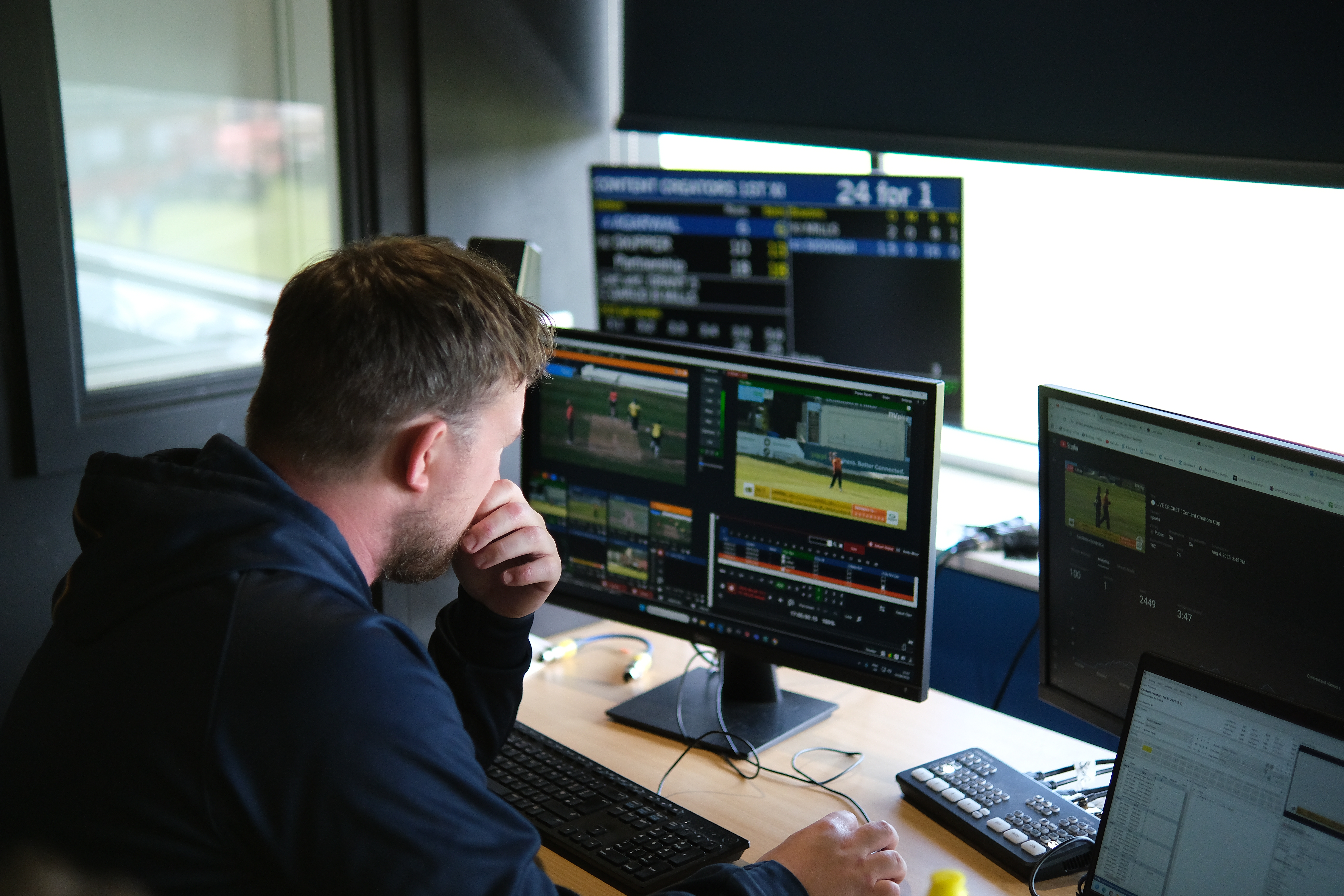 Match day operator considering live stream on monitor in control room