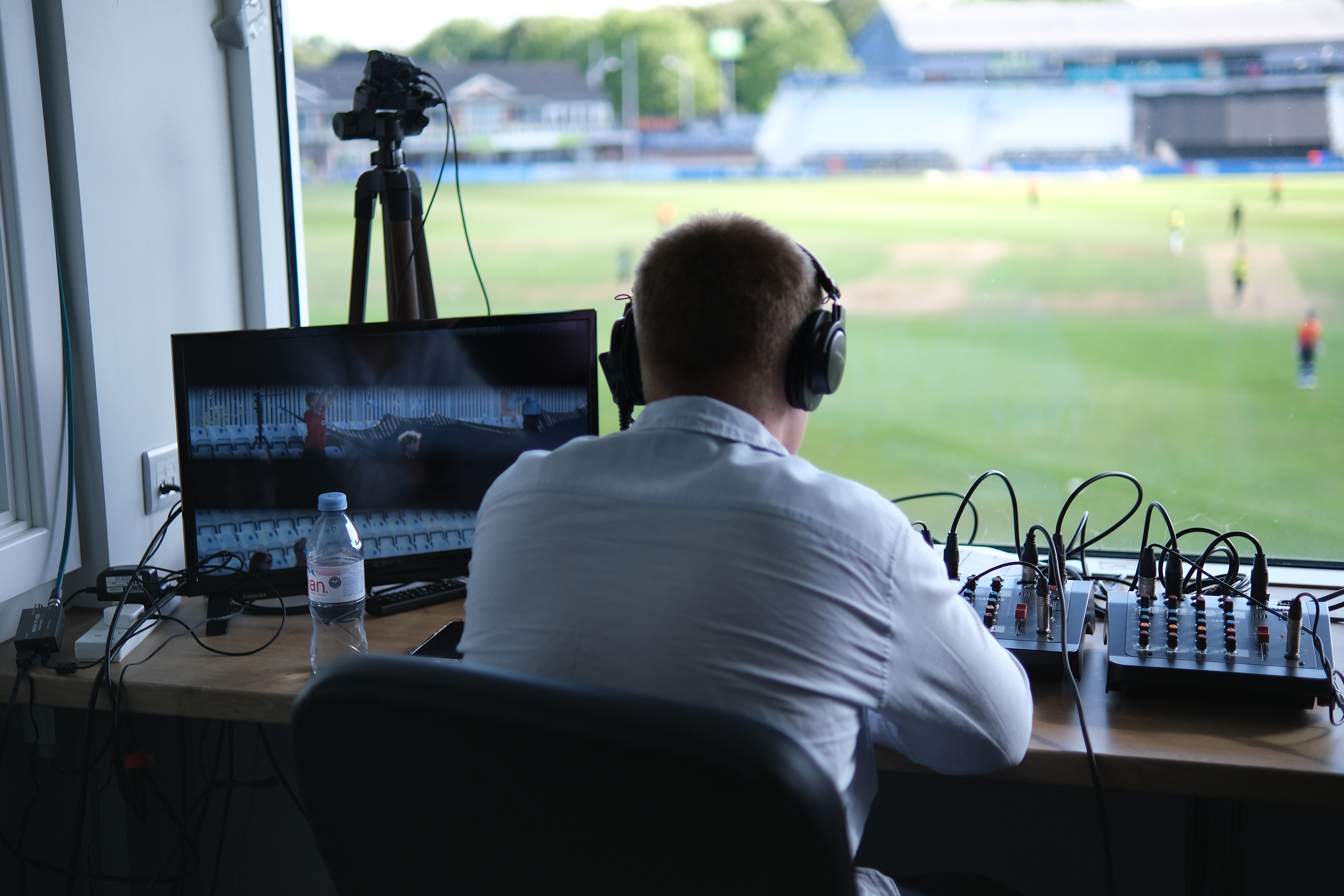 Match day operator in control room watching cricket match and running live stream