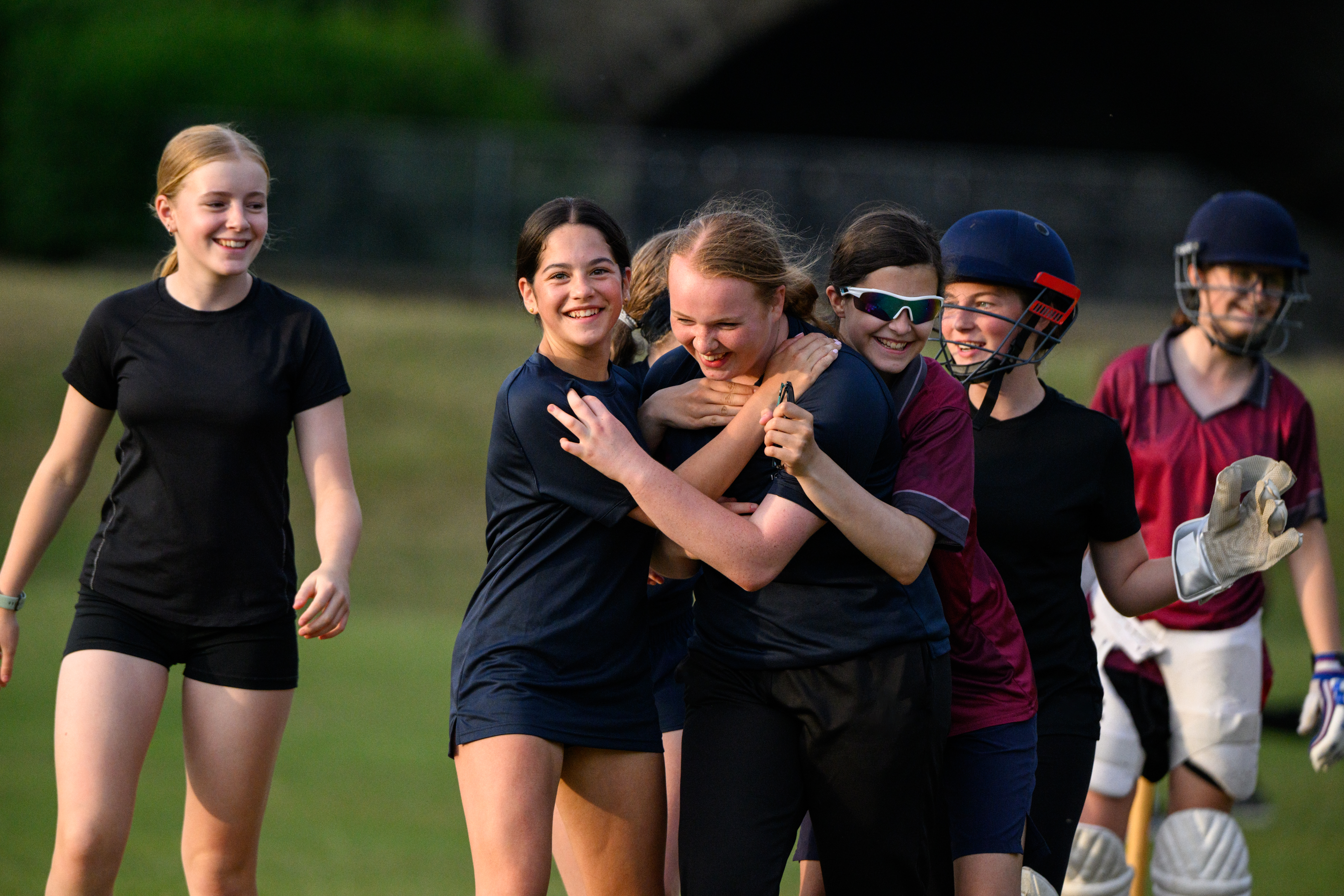 Group of girls celebrating after cricket training session